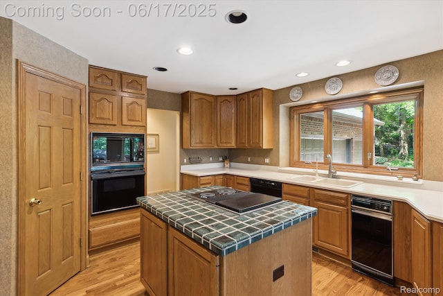 2020 Pine Hollow Trl, Brighton, MI 48114 - kitchen with black appliances, tile countertops, light wood-style floors, a center island, and brown cabinets
