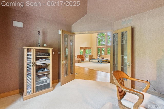 2020 Pine Hollow Trl, Brighton, MI 48114 - corridor featuring french doors, carpet, wood finished floors, and lofted ceiling