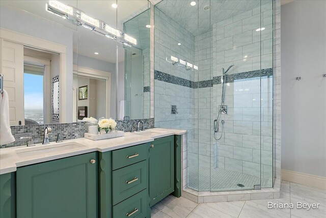 335 Bridge St NW Unit 3102, Grand Rapids, MI 49504 - bathroom with marble finish floors, a stall shower, double vanity, and decorative backsplash