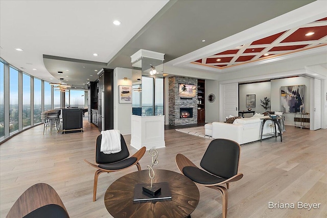 335 Bridge St NW Unit 3102, Grand Rapids, MI 49504 - living room with light wood finished floors, a fireplace, floor to ceiling windows, recessed lighting, and crown molding