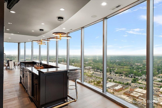 335 Bridge St NW Unit 3102, Grand Rapids, MI 49504 - kitchen with a wall of windows, wood finished floors, recessed lighting, pendant lighting, and a kitchen island