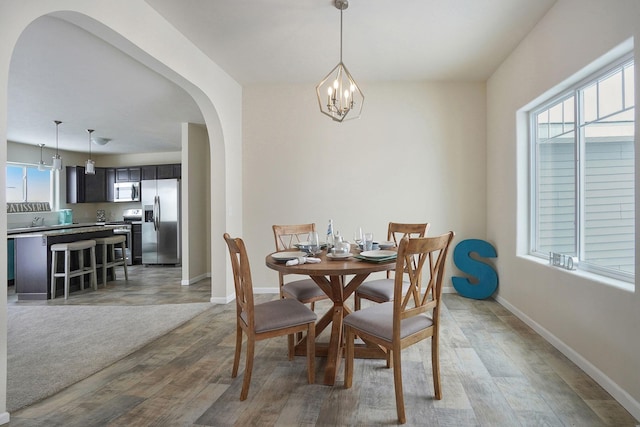 LOT106 Butternut Dr, Wayland, MI 49348 - dining room featuring arched walkways, a chandelier, and light wood-type flooring
