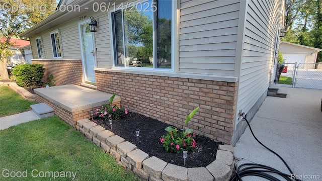 8544 Russell St, Shelby Twp, MI 48317 - view of home's exterior with brick siding, a gate, and a garage