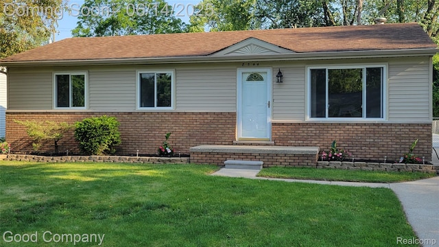 8544 Russell St, Shelby Twp, MI 48317 - view of front of home featuring brick siding, a front yard, and roof with shingles