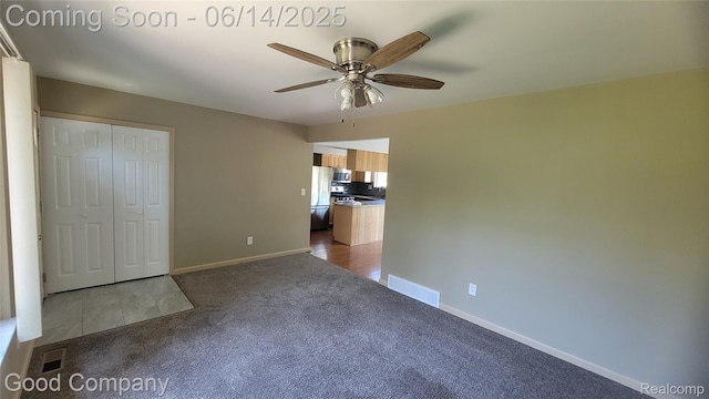 8544 Russell St, Shelby Twp, MI 48317 - unfurnished living room with dark colored carpet and ceiling fan