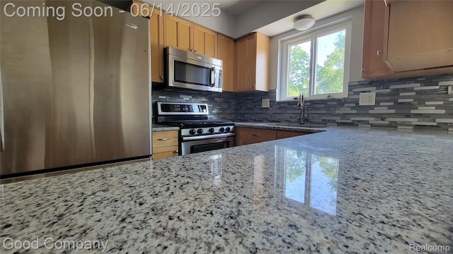 8544 Russell St, Shelby Twp, MI 48317 - kitchen featuring stainless steel appliances, light stone counters, and backsplash