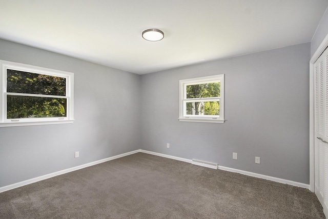 6737 Cypress St, Portage, MI 49024 - unfurnished bedroom with dark carpet and a closet