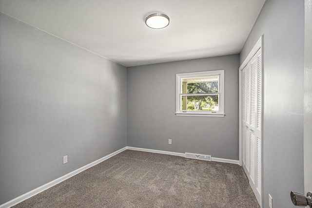 6737 Cypress St, Portage, MI 49024 - unfurnished bedroom featuring a closet and dark colored carpet