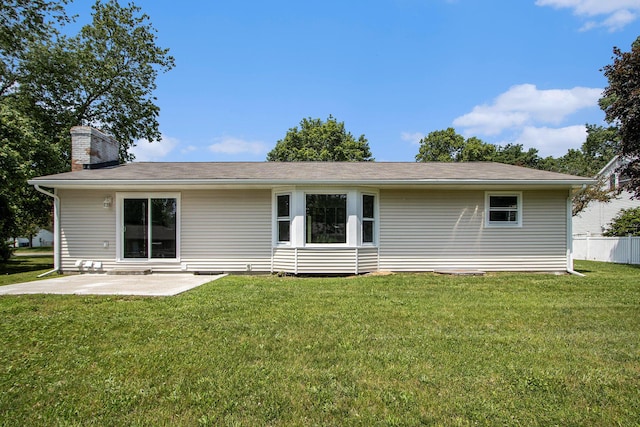 6737 Cypress St, Portage, MI 49024 - rear view of property featuring a lawn, a chimney, and a patio