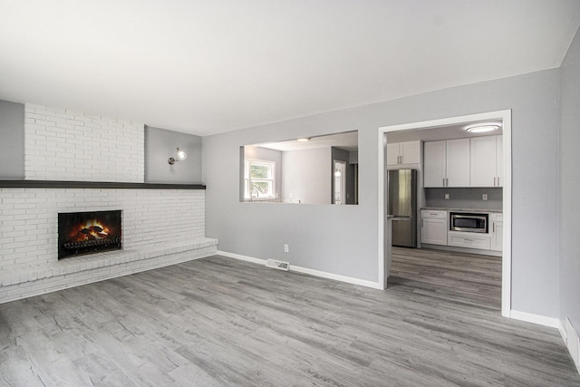 6737 Cypress St, Portage, MI 49024 - unfurnished living room with a fireplace and wood finished floors