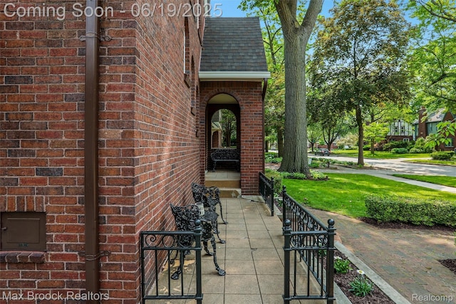 11 Sylvan Ave, Pleasant Ridge, MI 48069 - view of exterior entry featuring brick siding and a shingled roof