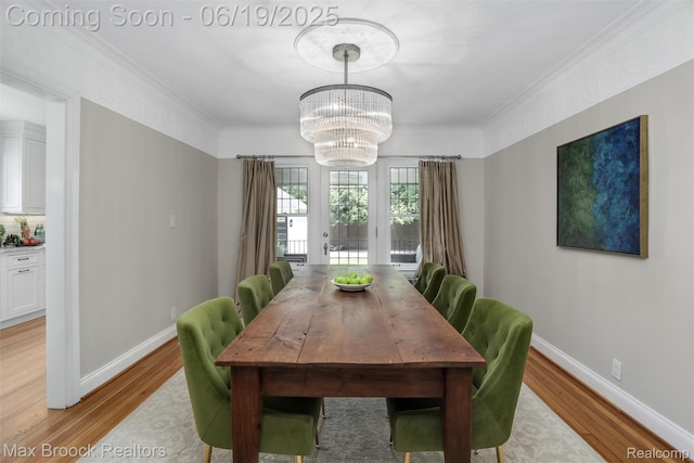 11 Sylvan Ave, Pleasant Ridge, MI 48069 - dining area with light wood finished floors, a chandelier, and crown molding
