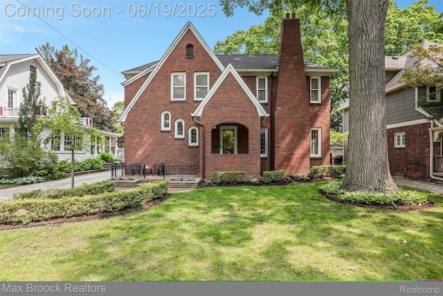 11 Sylvan Ave, Pleasant Ridge, MI 48069 - tudor-style house featuring a chimney, brick siding, and a front lawn