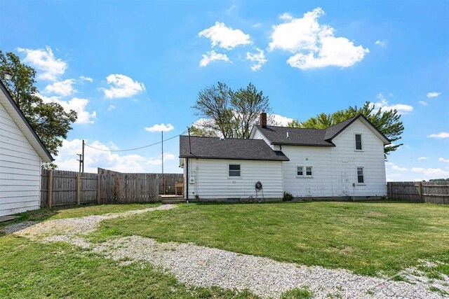 490 W Wilder Rd, Auburn, MI 48611 - back of house featuring a fenced backyard, a chimney, and a shingled roof