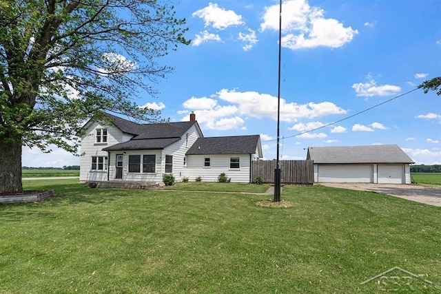 490 W Wilder Rd, Auburn, MI 48611 - rear view of house featuring a detached garage, a chimney, and an outbuilding