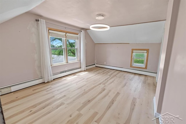 490 W Wilder Rd, Auburn, MI 48611 - additional living space featuring vaulted ceiling, healthy amount of natural light, a baseboard heating unit, and wood finished floors