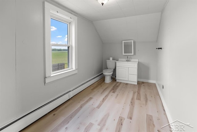 490 W Wilder Rd, Auburn, MI 48611 - half bathroom with baseboard heating, wood finished floors, vanity, and vaulted ceiling