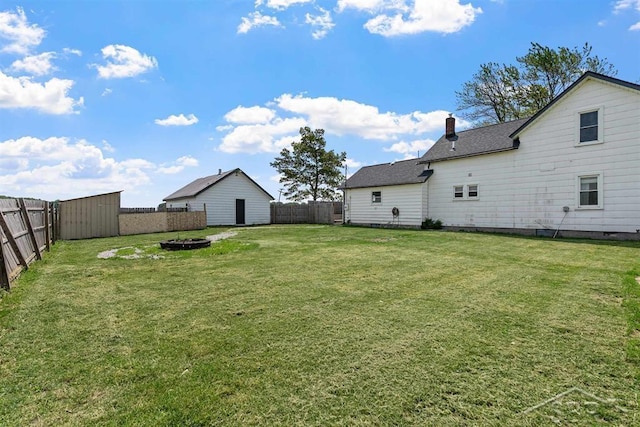 490 W Wilder Rd, Auburn, MI 48611 - fenced backyard with an outdoor fire pit and a shed