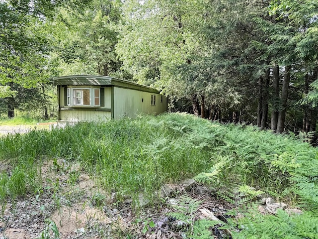 7671 S 27th Rd, Cadillac, MI 49601 - view of yard with an outbuilding and a forest view