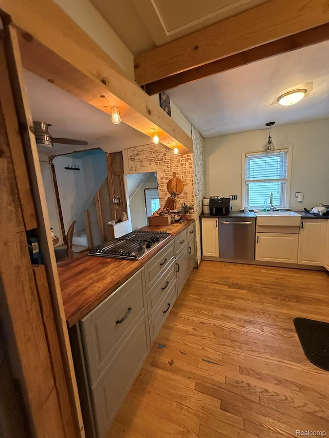 11311 Tecumseh, Redford, MI 48239 - kitchen with appliances with stainless steel finishes, light wood-style flooring, white cabinetry, beam ceiling, and pendant lighting