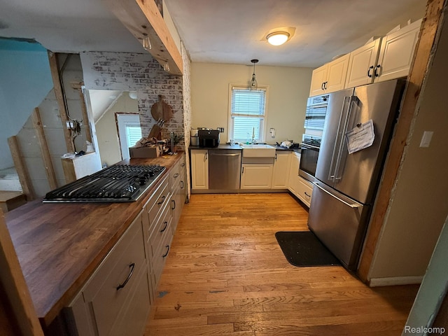 11311 Tecumseh, Redford, MI 48239 - kitchen with black appliances, light wood-type flooring, decorative light fixtures, and butcher block counters