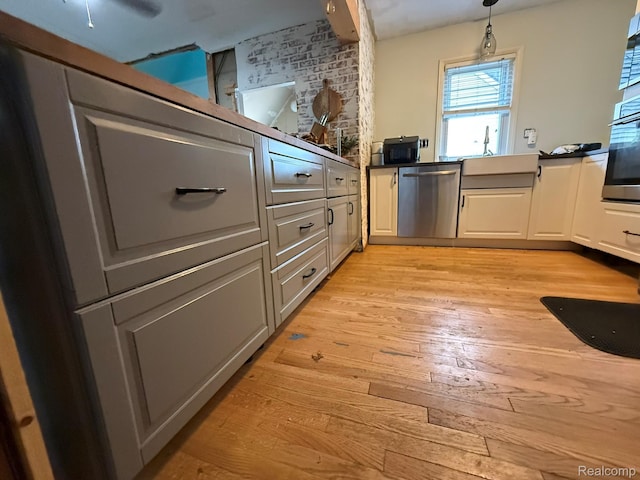 11311 Tecumseh, Redford, MI 48239 - kitchen featuring appliances with stainless steel finishes, light wood finished floors, decorative light fixtures, and white cabinets