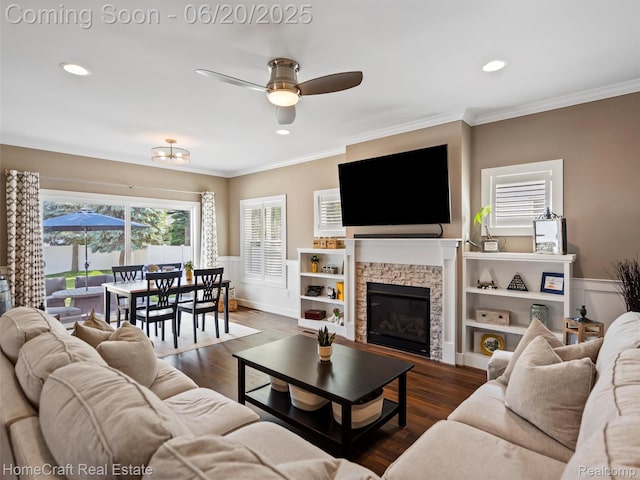 2213 Beverly Blvd, Berkley, MI 48072 - living area featuring a ceiling fan, crown molding, a stone fireplace, wood finished floors, and a wainscoted wall