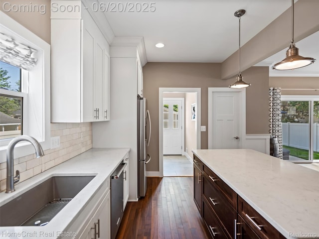 2213 Beverly Blvd, Berkley, MI 48072 - kitchen with recessed lighting, stainless steel appliances, tasteful backsplash, white cabinetry, and dark brown cabinetry
