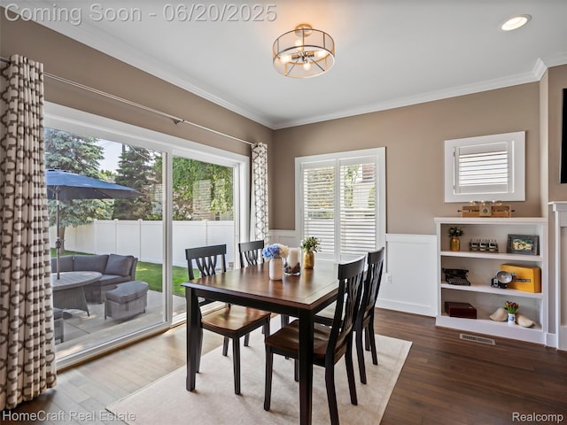 2213 Beverly Blvd, Berkley, MI 48072 - dining space featuring plenty of natural light, crown molding, wood finished floors, a wainscoted wall, and a chandelier