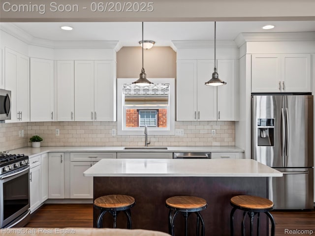 2213 Beverly Blvd, Berkley, MI 48072 - kitchen with stainless steel appliances, a kitchen bar, light countertops, white cabinetry, and recessed lighting