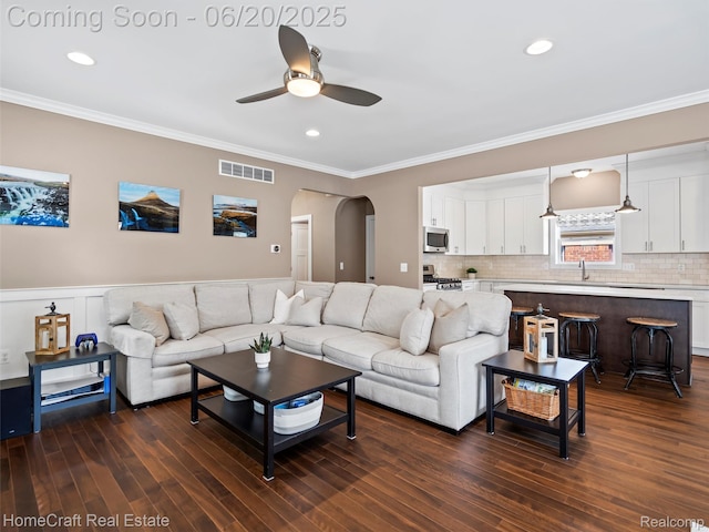 2213 Beverly Blvd, Berkley, MI 48072 - living area with arched walkways, ceiling fan, ornamental molding, dark wood-style flooring, and recessed lighting