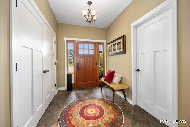 2331 Deer Trail Dr NE, Grand Rapids, MI 49505 - entrance foyer with stone tile floors and a chandelier