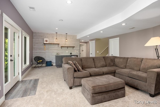 2331 Deer Trail Dr NE, Grand Rapids, MI 49505 - living area with an accent wall, recessed lighting, plenty of natural light, bar, and french doors