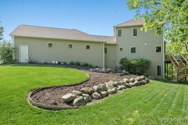 2331 Deer Trail Dr NE, Grand Rapids, MI 49505 - rear view of house with stairway, a yard, and a deck
