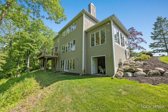 2331 Deer Trail Dr NE, Grand Rapids, MI 49505 - back of property with a lawn, a chimney, and a wooden deck