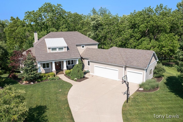 2331 Deer Trail Dr NE, Grand Rapids, MI 49505 - view of front of house featuring a chimney, an attached garage, driveway, and a front lawn