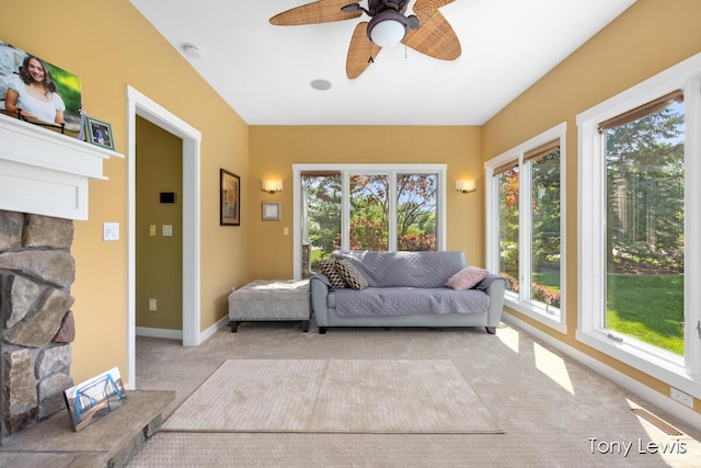 2331 Deer Trail Dr NE, Grand Rapids, MI 49505 - carpeted living room with a ceiling fan and a stone fireplace