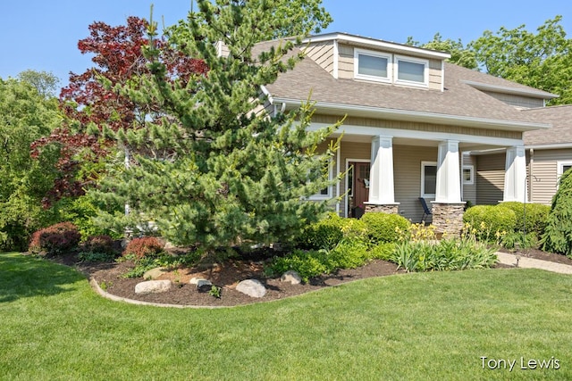 2331 Deer Trail Dr NE, Grand Rapids, MI 49505 - craftsman-style home with roof with shingles, a front lawn, and covered porch