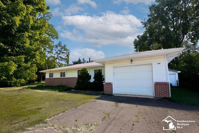 6200 Jackman Rd, Temperance, MI 48182 - ranch-style house featuring brick siding, a front yard, a garage, and asphalt driveway