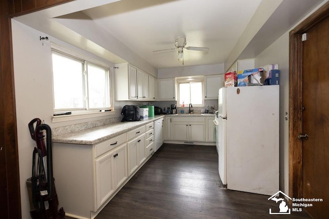 6200 Jackman Rd, Temperance, MI 48182 - kitchen with white appliances, ceiling fan, light countertops, white cabinets, and dark wood finished floors