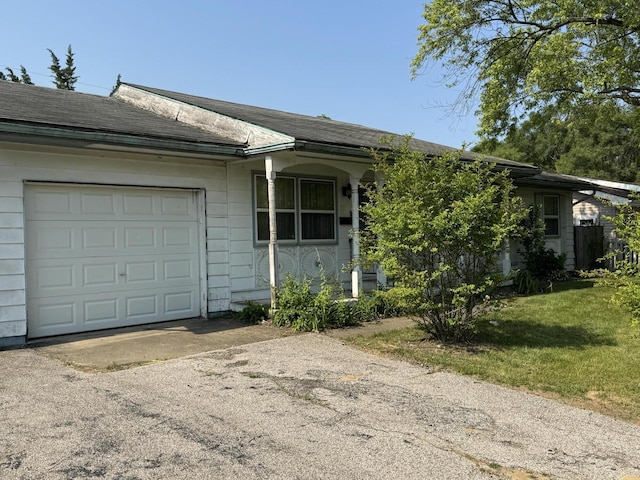 2456 Kurt Rd, Benton Harbor, MI 49022 - view of front facade with driveway, an attached garage, a shingled roof, and a front yard