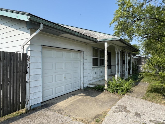 2456 Kurt Rd, Benton Harbor, MI 49022 - view of side of home featuring a porch, an attached garage, and driveway