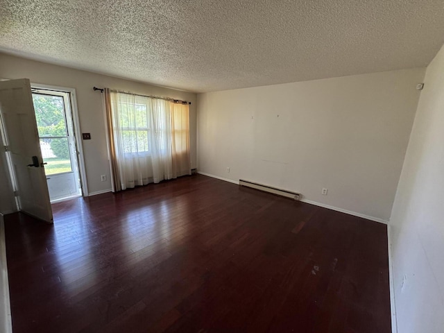 2456 Kurt Rd, Benton Harbor, MI 49022 - unfurnished room with a baseboard heating unit, a textured ceiling, and dark wood-style flooring