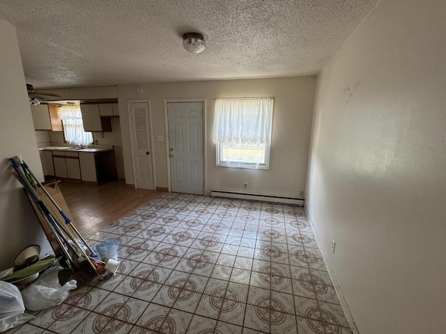 2456 Kurt Rd, Benton Harbor, MI 49022 - entryway featuring a baseboard radiator, plenty of natural light, and a textured ceiling