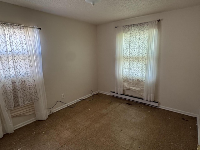 2456 Kurt Rd, Benton Harbor, MI 49022 - unfurnished room with a baseboard radiator, tile patterned floors, and a textured ceiling