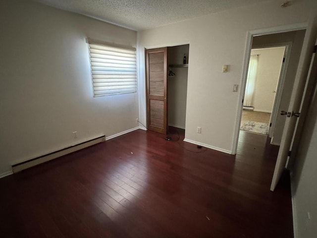 2456 Kurt Rd, Benton Harbor, MI 49022 - unfurnished bedroom featuring a baseboard radiator, wood finished floors, a closet, and a textured ceiling