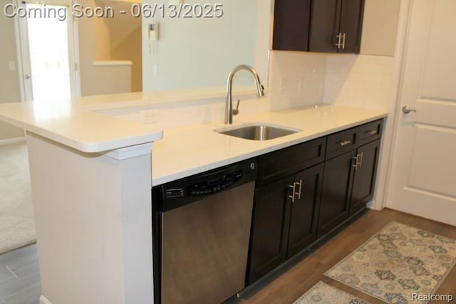 23413 Williamsburg Cir Unit 12, Woodhaven, MI 48183 - kitchen featuring dishwasher, light countertops, a peninsula, and wood finished floors