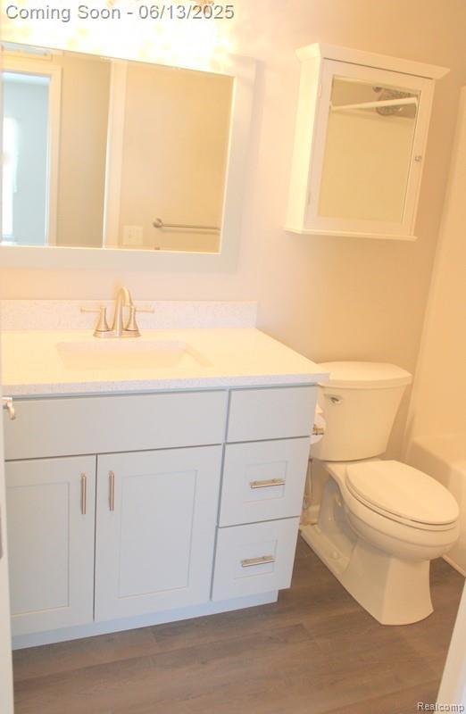 23413 Williamsburg Cir Unit 12, Woodhaven, MI 48183 - full bathroom with vanity and wood finished floors