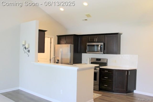 23413 Williamsburg Cir Unit 12, Woodhaven, MI 48183 - kitchen featuring appliances with stainless steel finishes, light wood-type flooring, light countertops, lofted ceiling, and recessed lighting