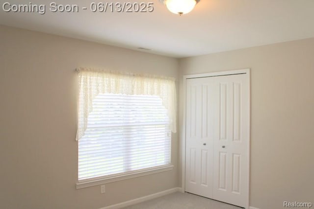23413 Williamsburg Cir Unit 12, Woodhaven, MI 48183 - unfurnished bedroom with a closet and baseboards